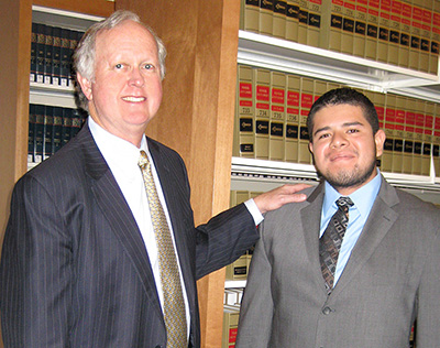 Terry Conner (left), managing partner for the law firm Haynes and Boone LLP, mentored Academic Bridge Program senior Fredi Garcia during his summer internship.  

